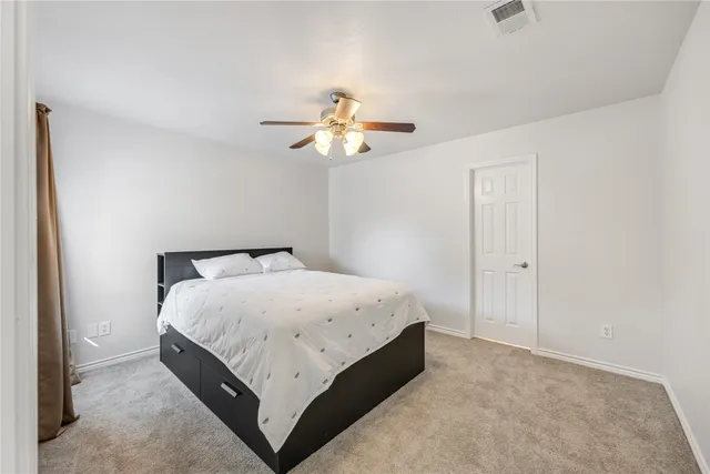 a bed room with a bed and a chandelier