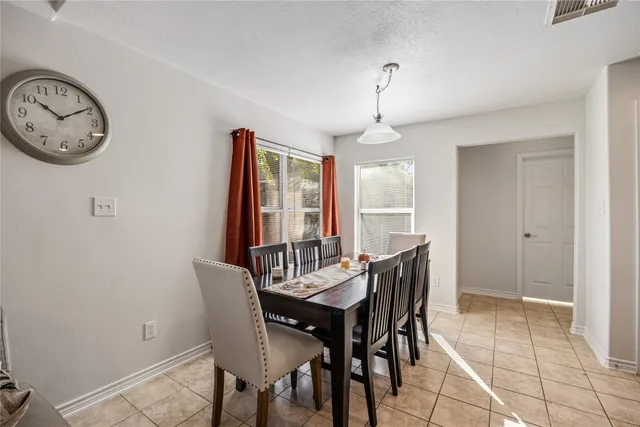 a view of a dining room with furniture and window
