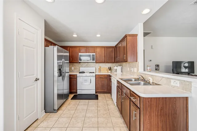 a kitchen with a sink stove and refrigerator