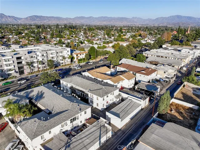 an aerial view of a houses with a city view