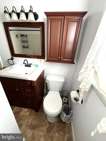a bathroom with a toilet sink and mirror