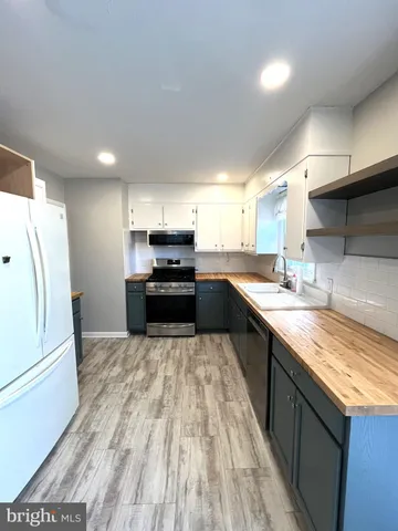 a large kitchen with a stove and a sink