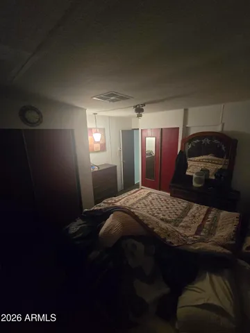 a bed sitting in a bedroom next to a window