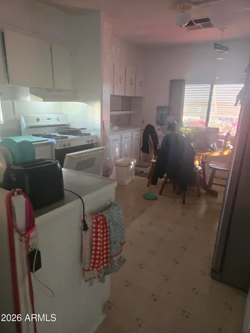 a kitchen with granite countertop a sink a stove and a refrigerator