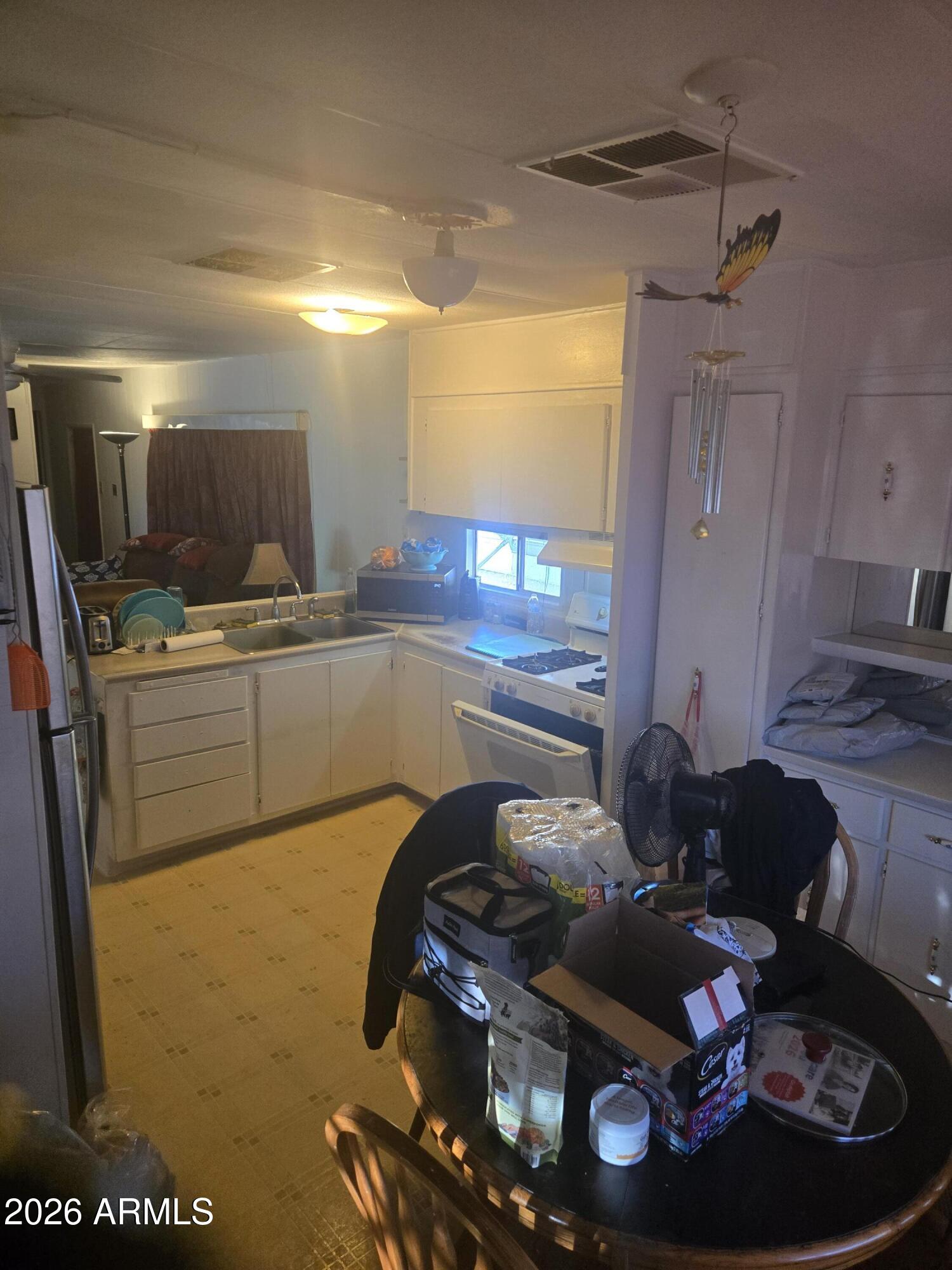 269 North Winchester Road, Unit 26 Apache Junction, AZ 85119 - Photo 4 of 18 a kitchen with stainless steel appliances granite countertop a stove and a sink
