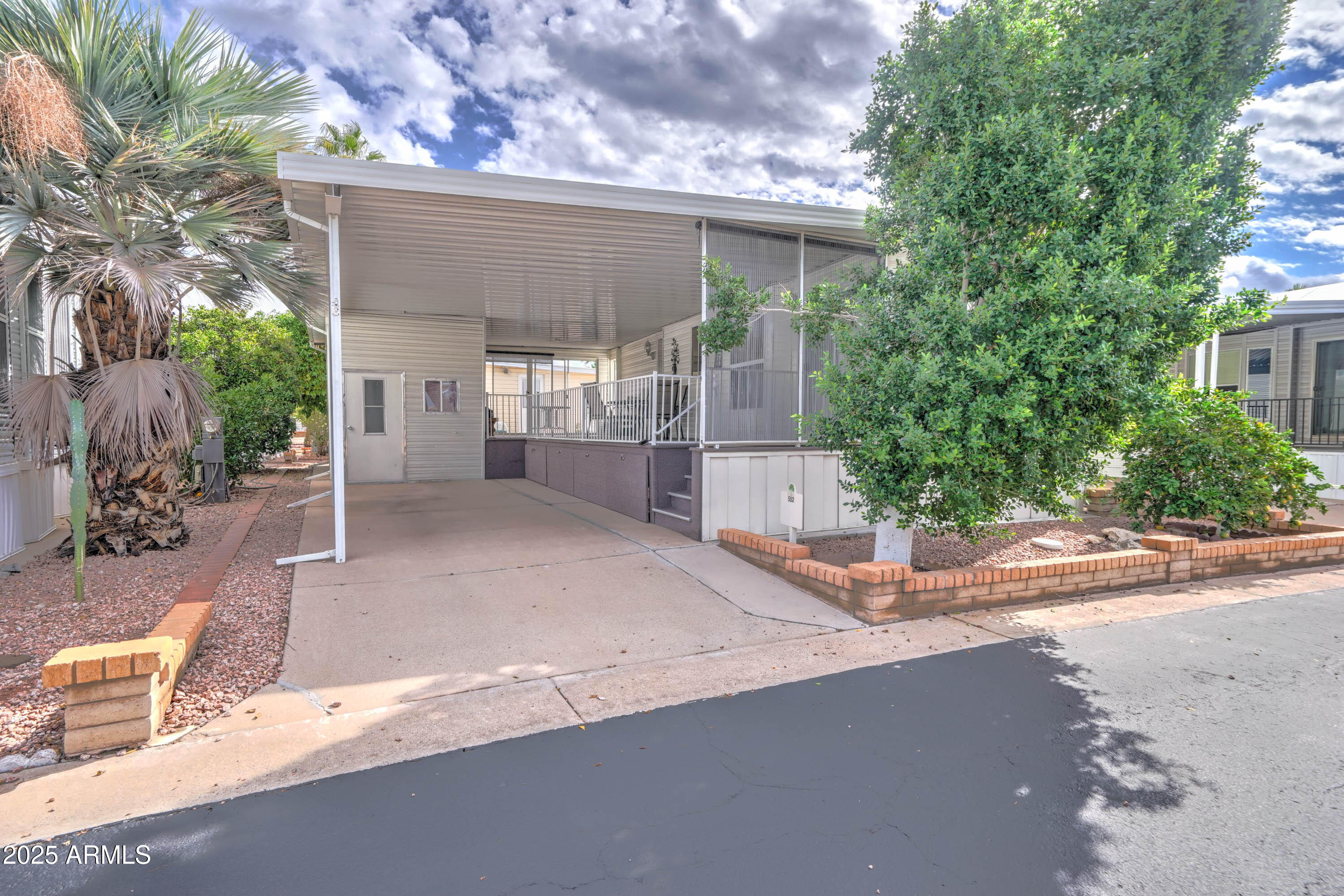 111 South Greenfield Road, Unit 552 Mesa, AZ 85206 - Photo 15 of 24 a view of a house with a yard and plants