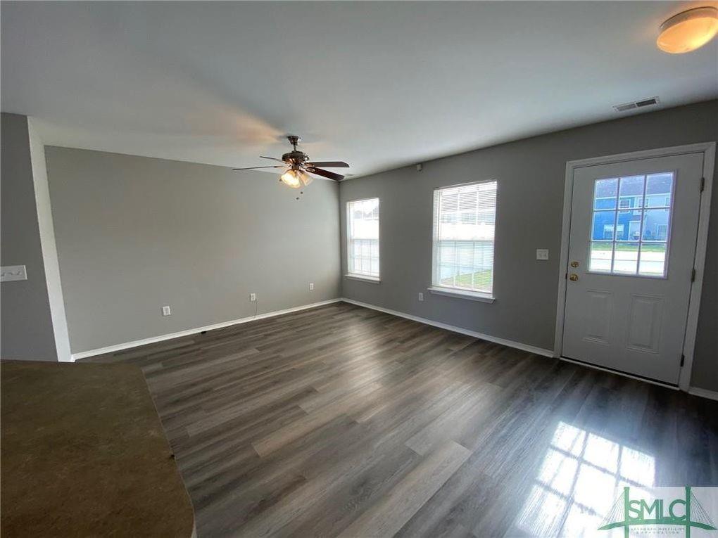 57 Timber Crest Court Savannah, GA 31407 - Photo 3 of 22 an empty room with wooden floor and windows