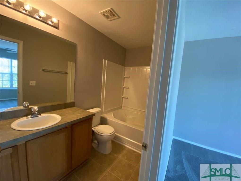 57 Timber Crest Court Savannah, GA 31407 - Photo 9 of 22 a bathroom with a granite countertop sink toilet a mirror and shower