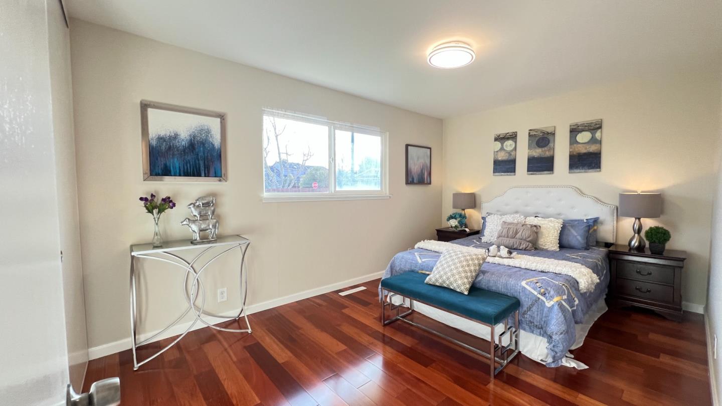 802 Humewick Way Sunnyvale, CA 94087 - Photo 7 of 11 a bedroom with a bed and wooden floor