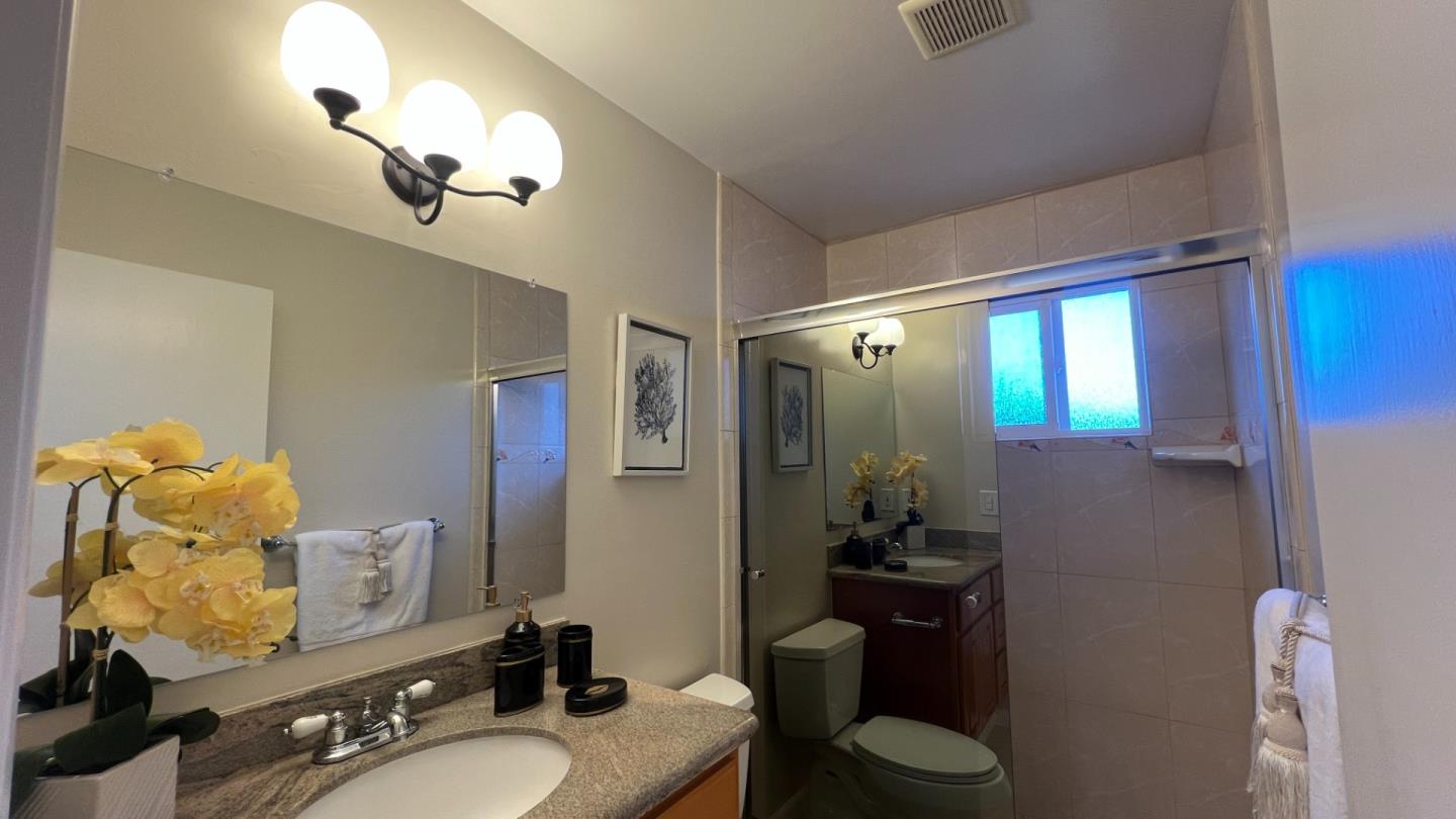802 Humewick Way Sunnyvale, CA 94087 - Photo 10 of 11 a bathroom with a granite countertop sink mirror and vanity