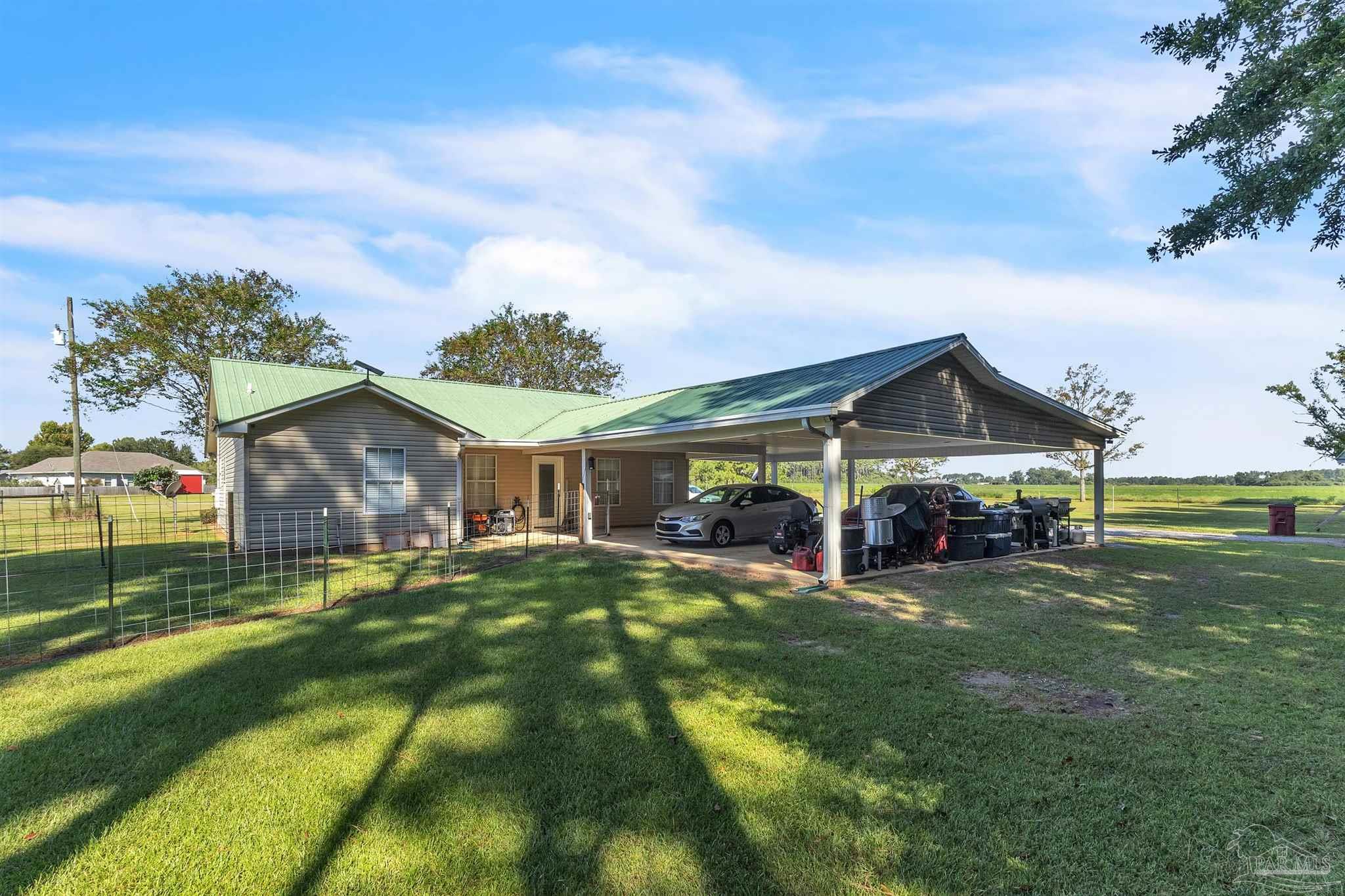 1770 Annie Penton Road Jay, FL 32565 - Photo 11 of 35 a view of a house with a big yard and large trees