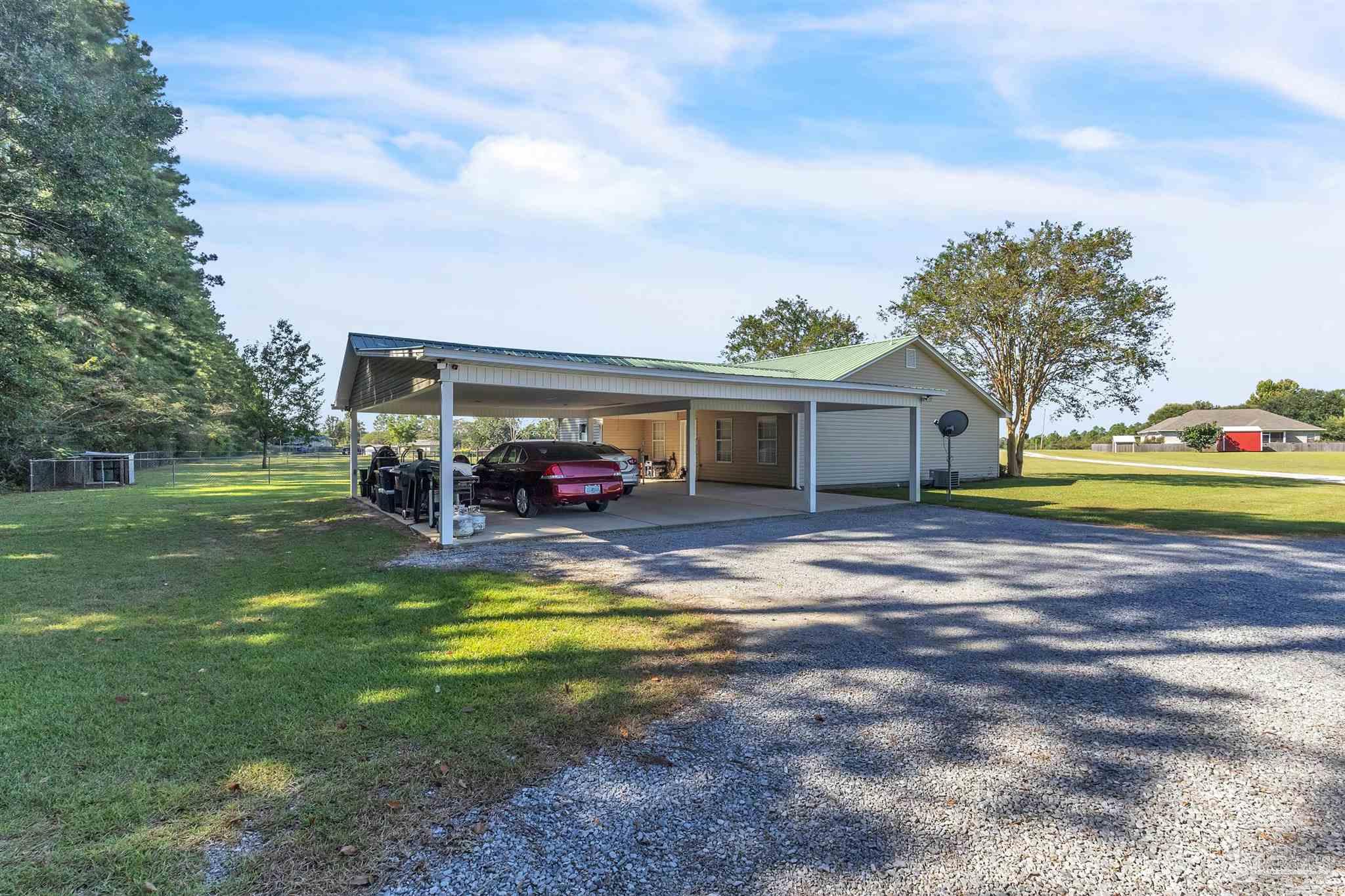 1770 Annie Penton Road Jay, FL 32565 - Photo 12 of 35 a view of a house with a big yard and large trees