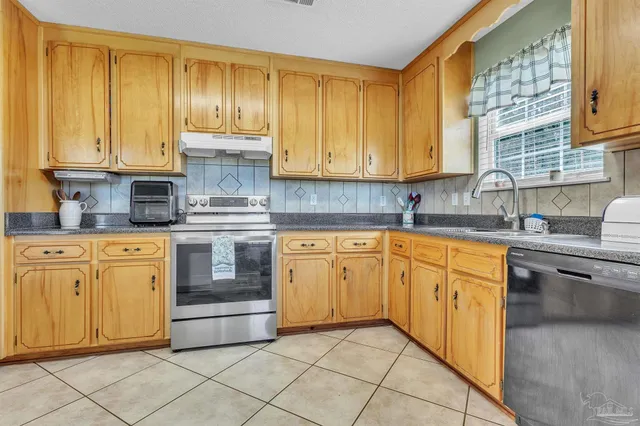a kitchen with cabinets stainless steel appliances and a sink