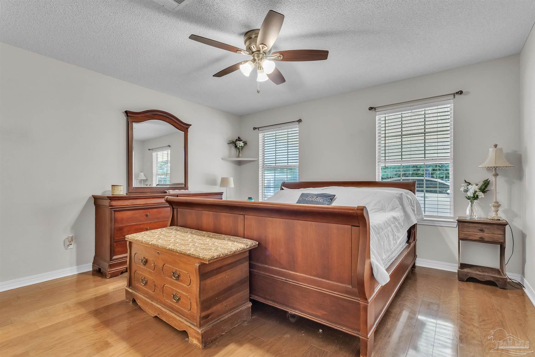 1770 Annie Penton Road Jay, FL 32565 - Photo 20 of 35 a spacious bedroom with a bed and a table