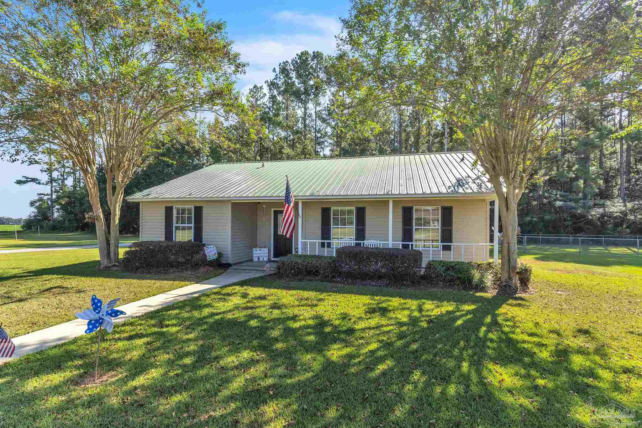 1770 Annie Penton Road Jay, FL 32565 - Photo 2 of 35 a view of a house with swimming pool and a yard