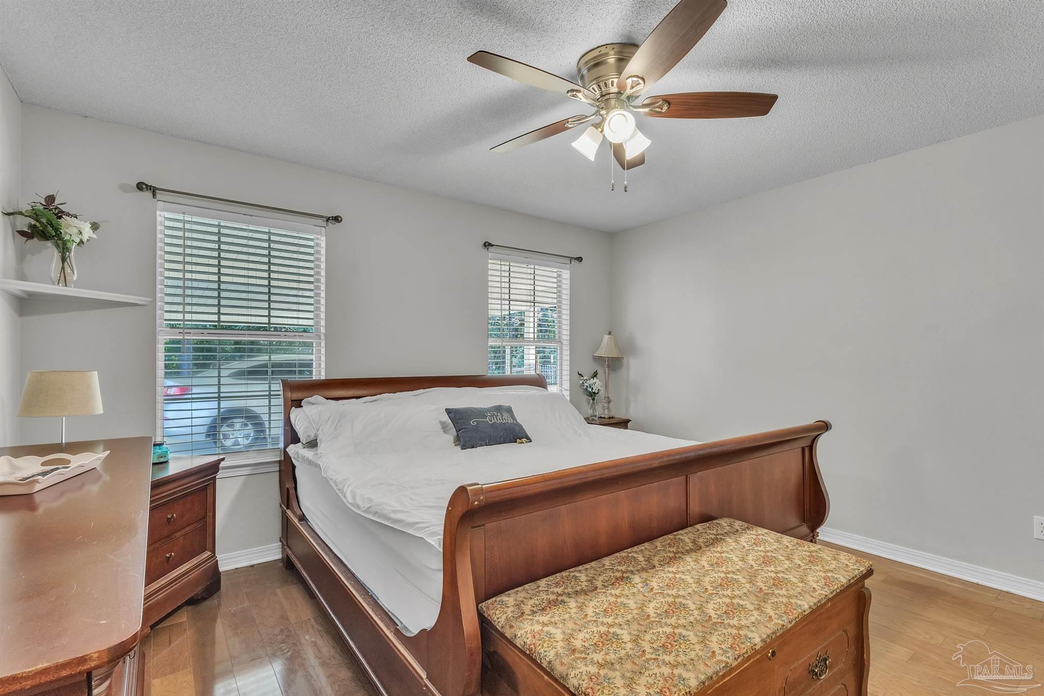 1770 Annie Penton Road Jay, FL 32565 - Photo 21 of 35 a bedroom with a bed and a chandelier