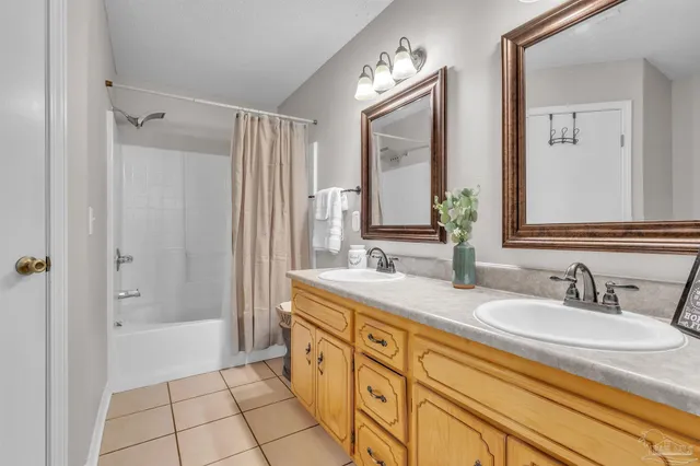 a bathroom with a granite countertop sink mirror and a bathtub