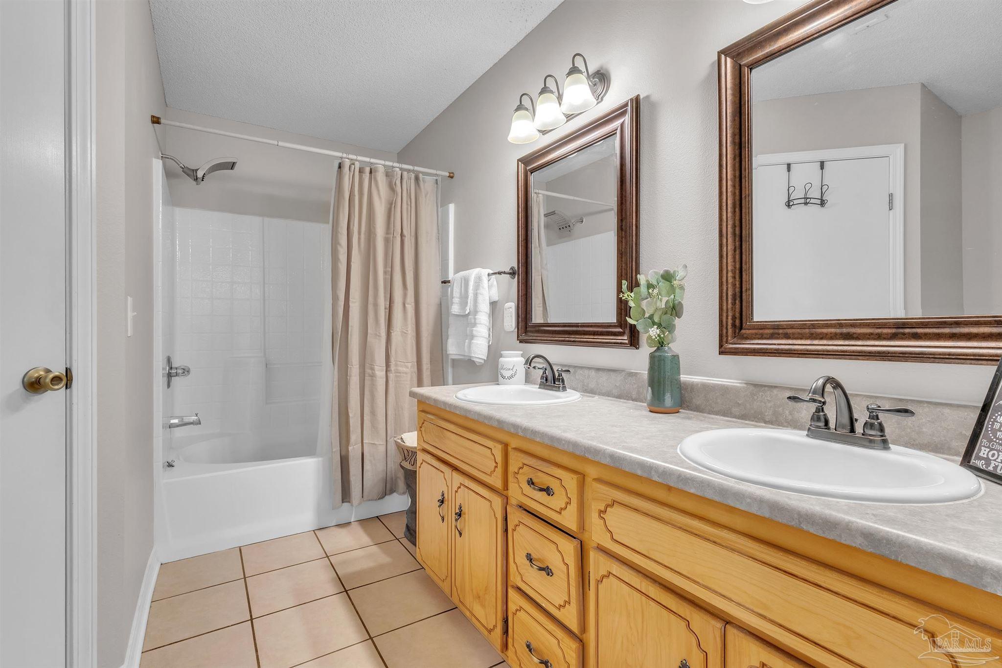 1770 Annie Penton Road Jay, FL 32565 - Photo 22 of 35 a bathroom with a granite countertop sink mirror and a bathtub