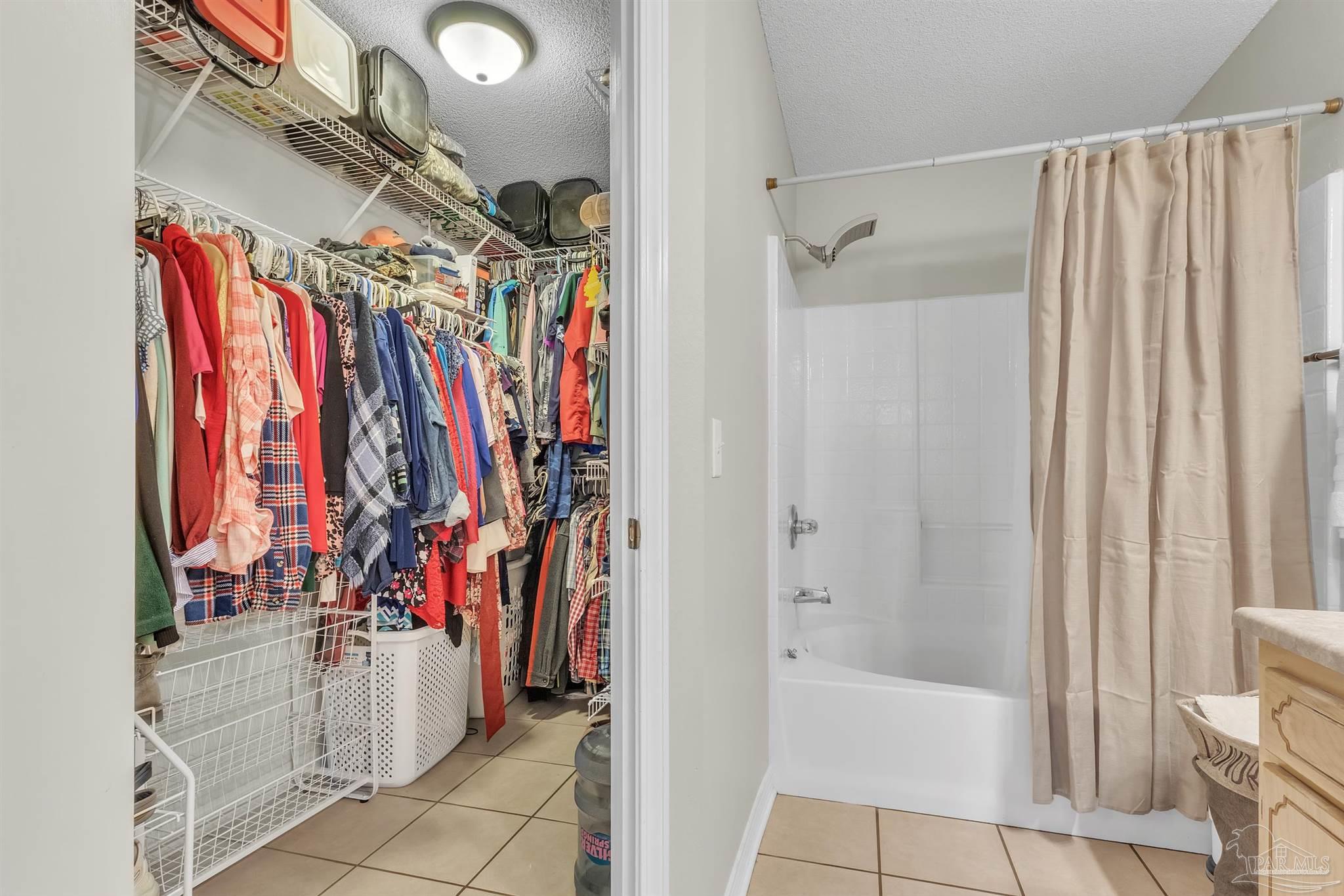 1770 Annie Penton Road Jay, FL 32565 - Photo 24 of 35 a view of walk in closet with clothes
