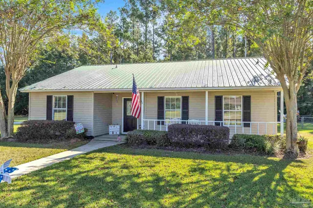 a front view of house with yard and outdoor seating
