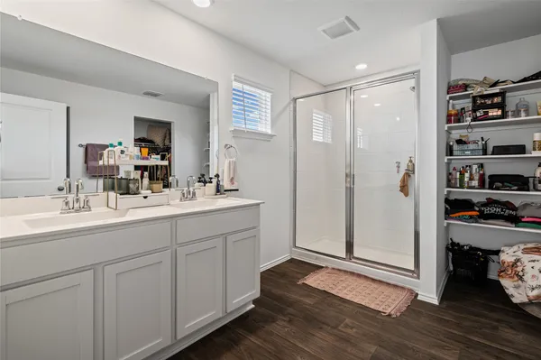 a bathroom with a double vanity sink and a mirror