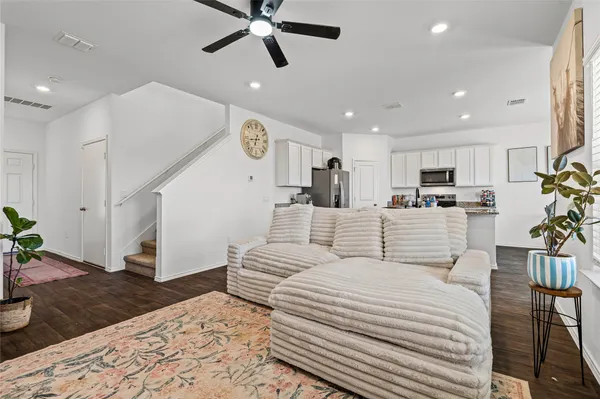 a large bedroom with a bed and a chandelier