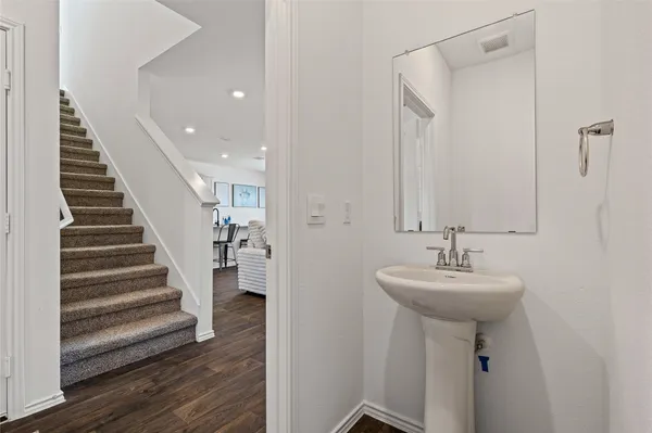 a bathroom with a sink toilet and a mirror