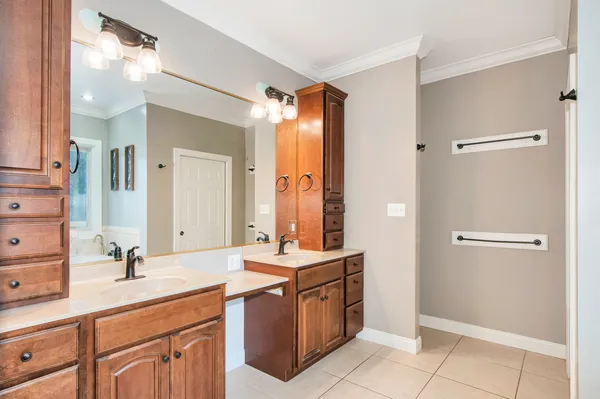 a bathroom with a double vanity sink mirror and shower