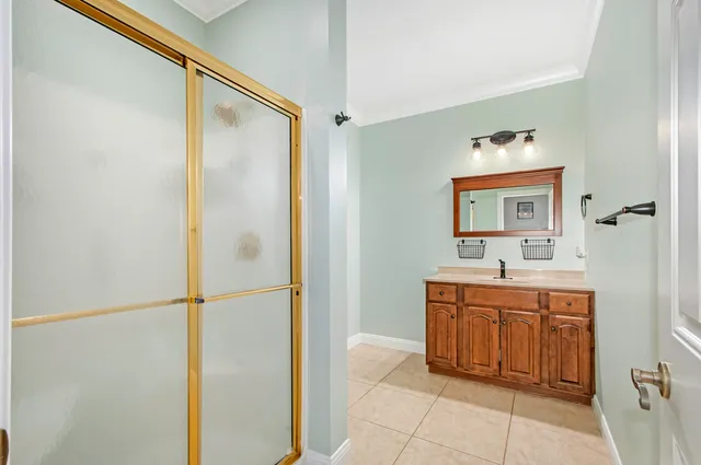 a bathroom with a sink a mirror and a shower