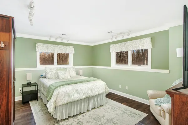 a bedroom with a bed and a window