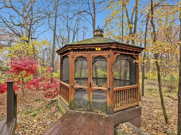 a front view of a house with wooden floor and lake view