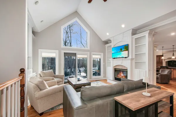 a living room with furniture a fireplace and a table