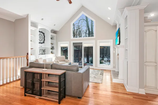 a living room with furniture and wooden floor