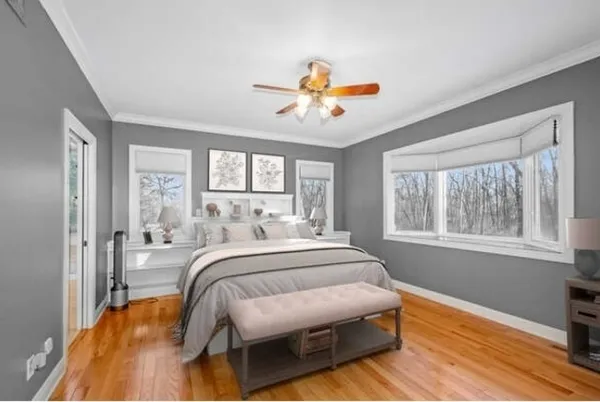 a bedroom with a bed couch and window