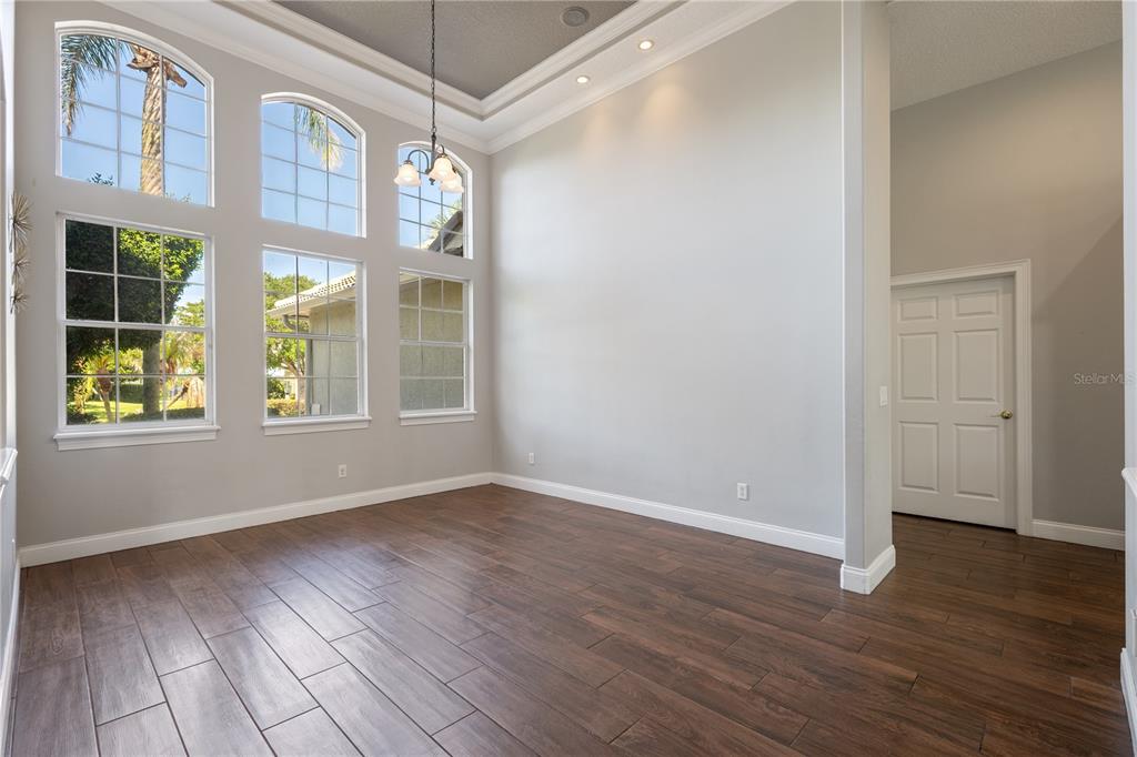2002 Water Key Drive Windermere, FL 34786 - Photo 7 of 60 a view of an empty room with wooden floor and a window