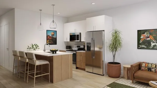 a kitchen with kitchen island a large counter top space appliances and cabinets