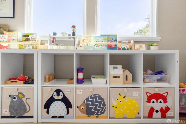 a utility room with lots of clutter and cabinets