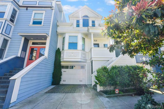 a view of a house with more windows and plants
