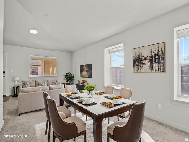 64 West 600 South, Unit C301 Springville, UT 84663 - Photo 7 of 40 Open-concept living and dining areas featuring neutral wall tones, multiple windows, and carpet flooring