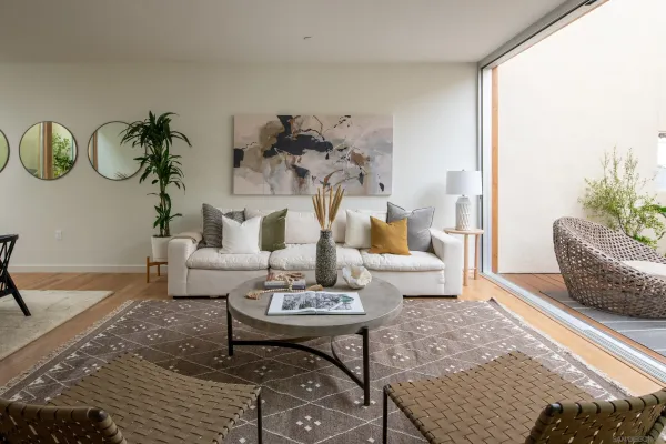 a living room with furniture and wooden floor