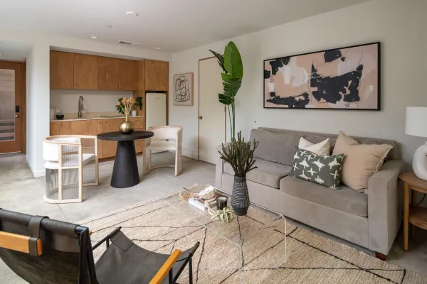 a living room with furniture and wooden floor