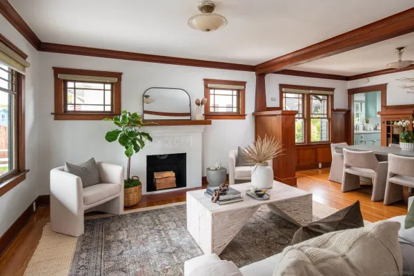 a living room with furniture fireplace and a large window