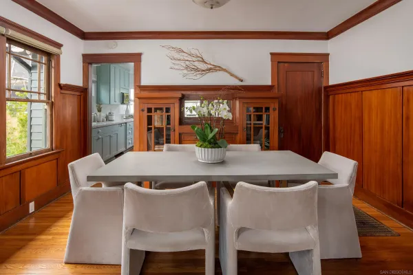 a dining table with chairs and window