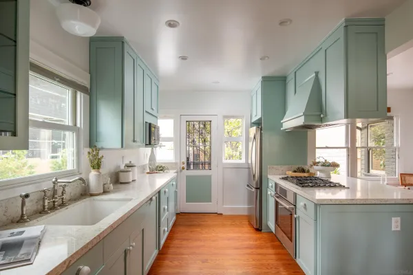 a kitchen with stainless steel appliances a sink stove and cabinets