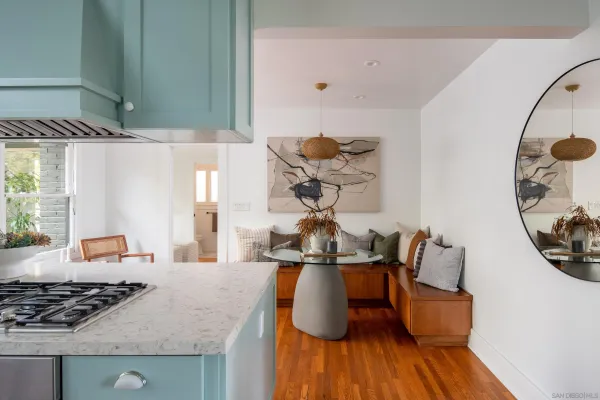 a kitchen with stainless steel appliances granite countertop a stove and a wooden floors