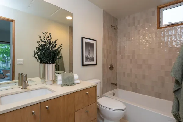a bathroom with a granite countertop sink a toilet and shower