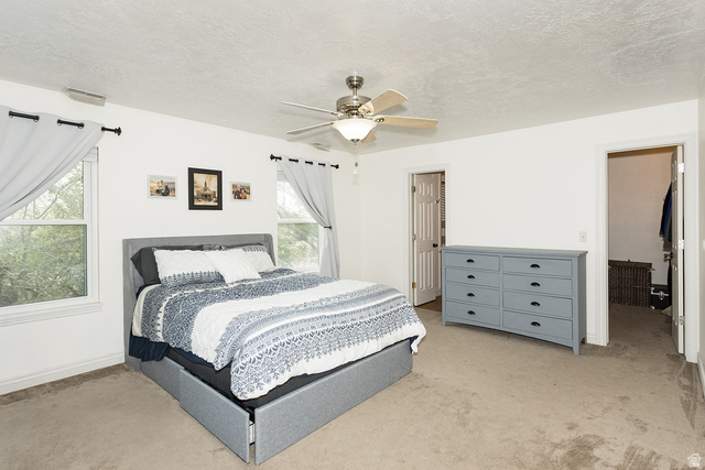 7797 North Windhover Road Eagle Mountain, UT 84005 - Photo 16 of 33 Carpeted room featuring a ceiling fan with integrated lighting, two windows, and a doorway leading to a closet space