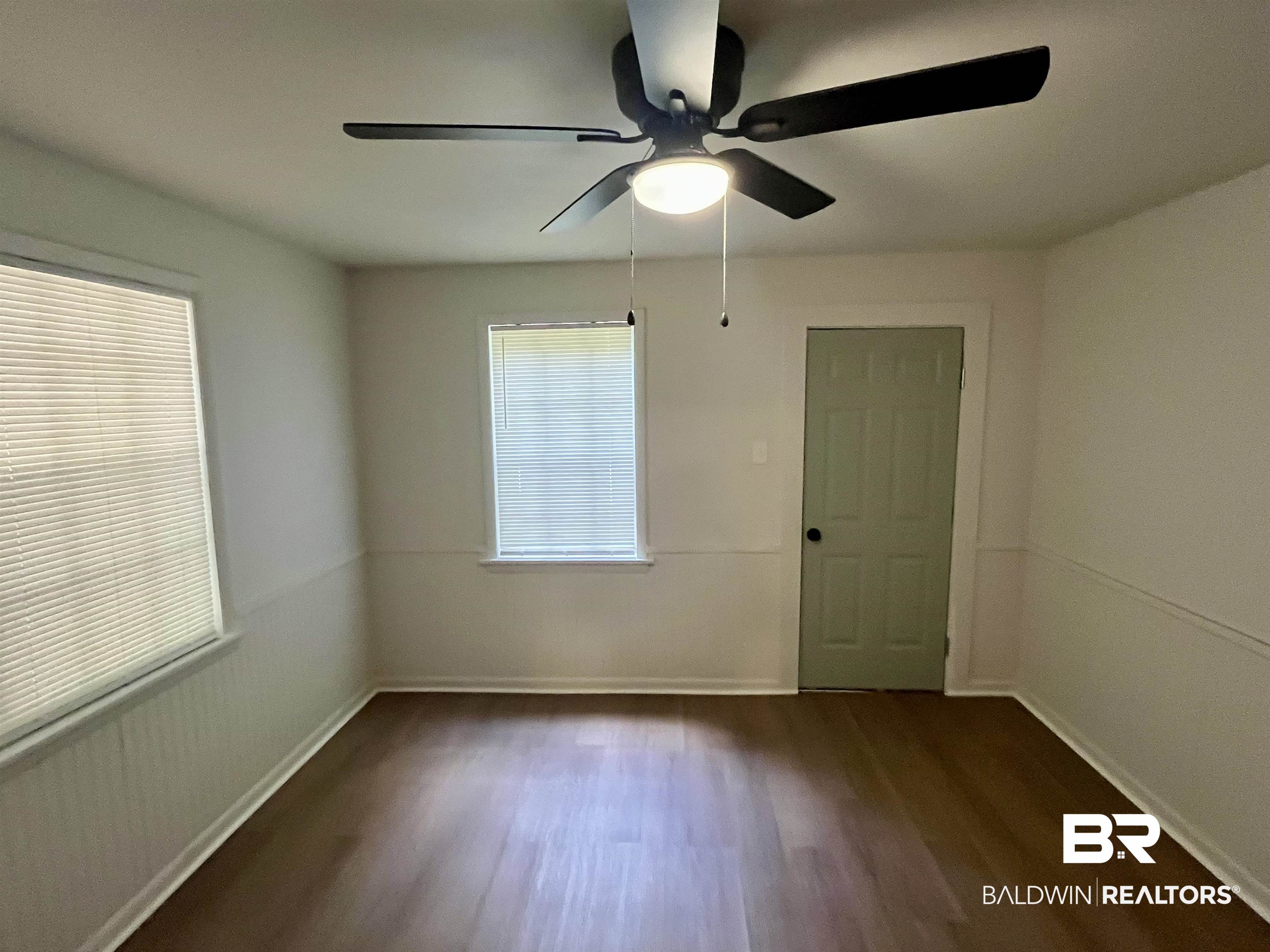 3105 Bryant Road Mobile, AL 36605 - Photo 31 of 39 Room featuring wood-finish flooring, white walls, and a prominent ceiling fan with integrated lighting