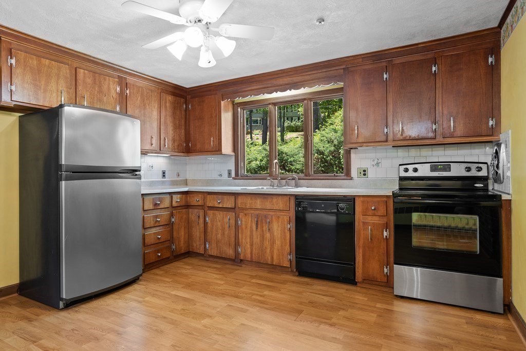 34 Duggan Road Acton, MA 01720 - Photo 12 of 42 a kitchen with kitchen island granite countertop a stove cabinets and refrigerator