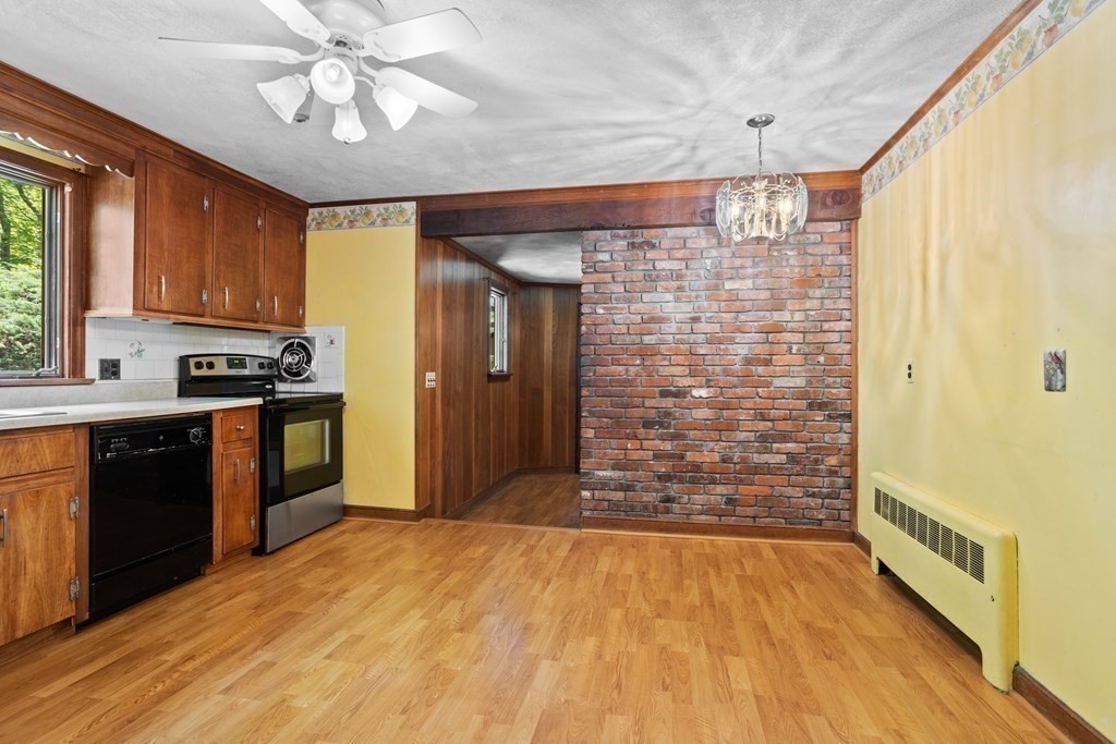 34 Duggan Road Acton, MA 01720 - Photo 14 of 42 a open kitchen with a refrigerator a stove top oven a sink and dishwasher with wooden floor